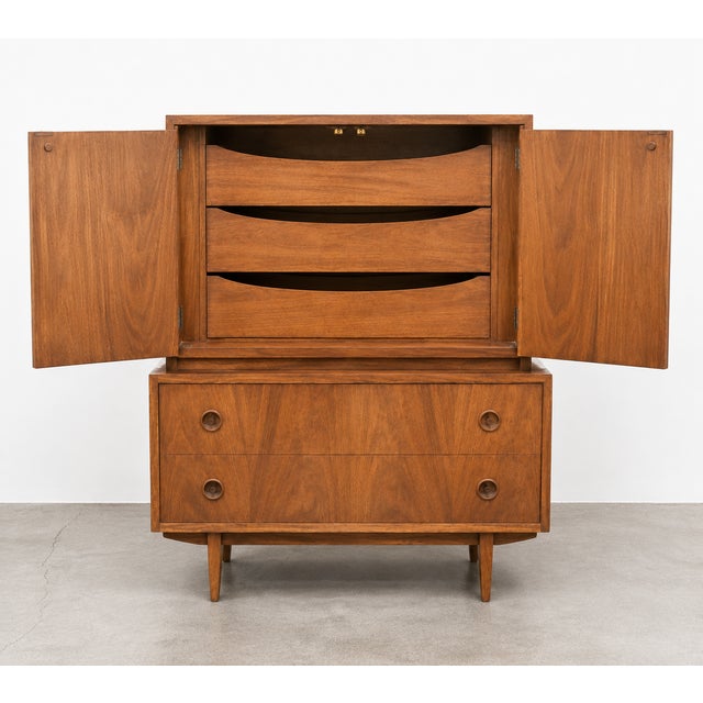 A mid-century modern gentleman's cabinet by American of Martinsville, crafted in walnut with the clean lines and...