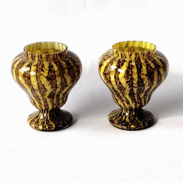 Yellow and brown Franz Welz Zig-Zag pattern spatter glass footed posy vases. Each stands about 4.75-inches tall with...