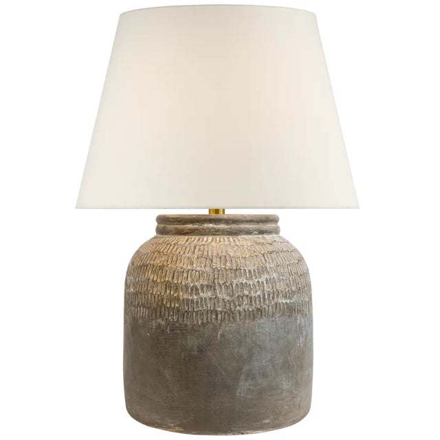 Exploring textural details in stoneware, the Indra Medium Table Lamp by Amber Lewis will create soft, ambient lighting in...
