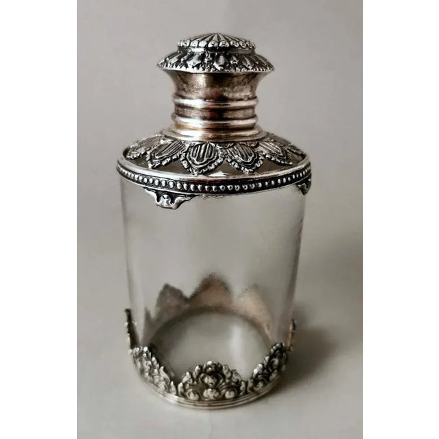 Original toilet bottle in Late Victorian style; on the body, made of smooth crystal, have been applied rich and elaborate...