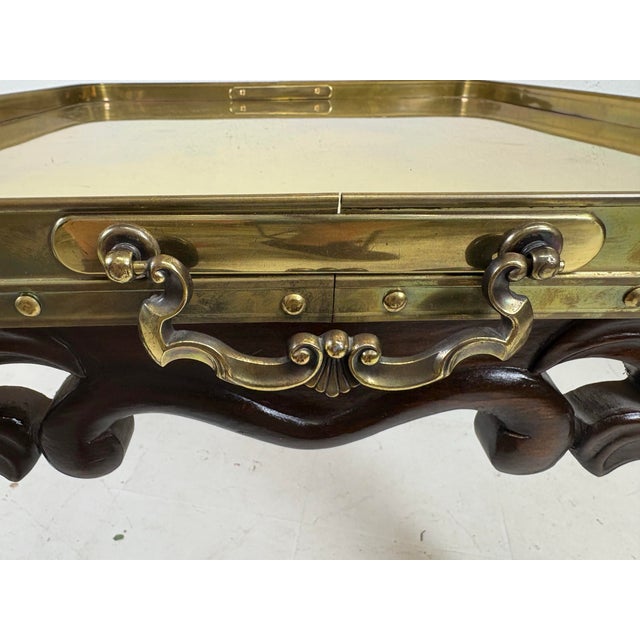 This is a vintage hand carved pine and brass galley style side table. This table has a beautifully hand carved pine base...