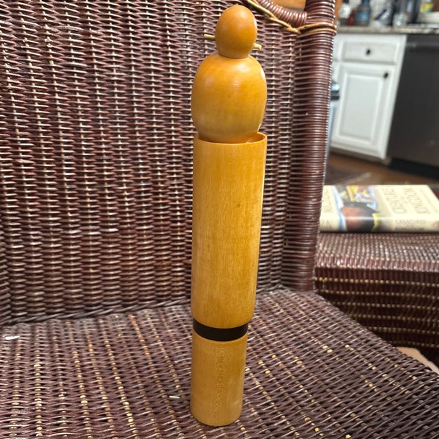 Vintage Sosaku Kokeshi Doll signed by the artist Sugai Sato characterized by a cylindrical wooden body and stylized...