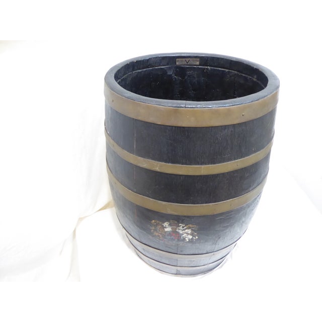 This antique British, brass bound barrel with painted shield, has a label explaining that the wood comes from old British...