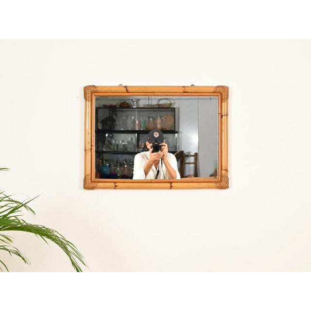 Wonderful Mid-Century organic rectangular mirror in rattan and handwoven wicker. This stylish French Riviera-style mirror...