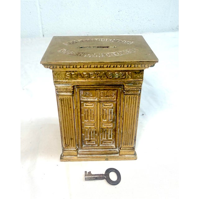 Up for sale is a rare antique Sparekassen, Denmark brass savings building still coin bank, featuring intricate designs and...