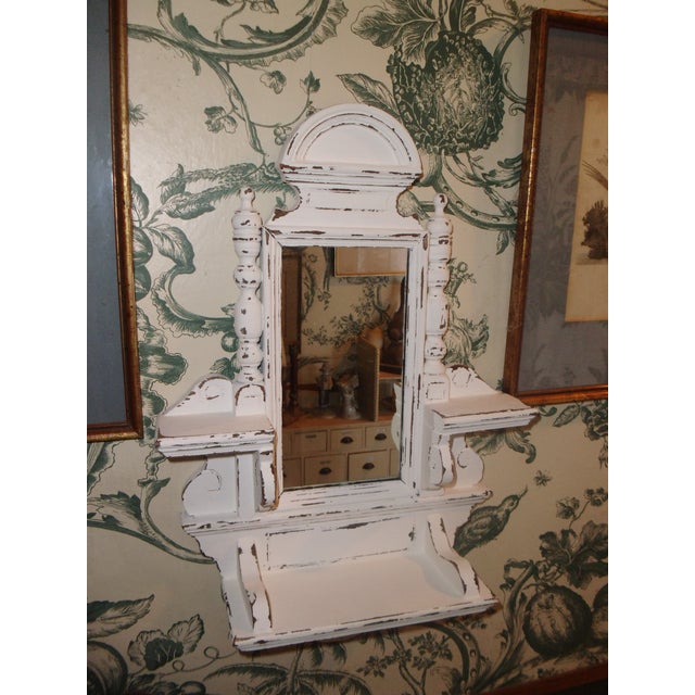 Romantic, antique, small wall mirror with 3 mini shelves, in a soft white shabby chic style. Mirror and hanger are not...