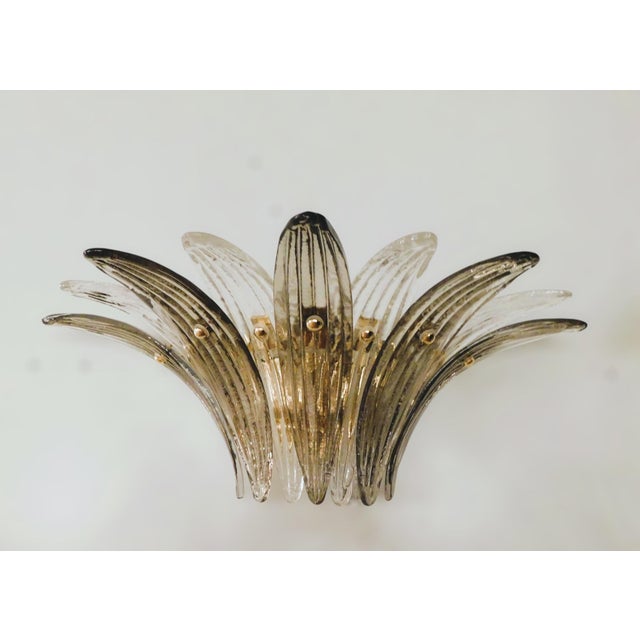 Italian wall light with hand blown clear and smoky Murano glass palmette leaves mounted on gold finish metal frame / Made...