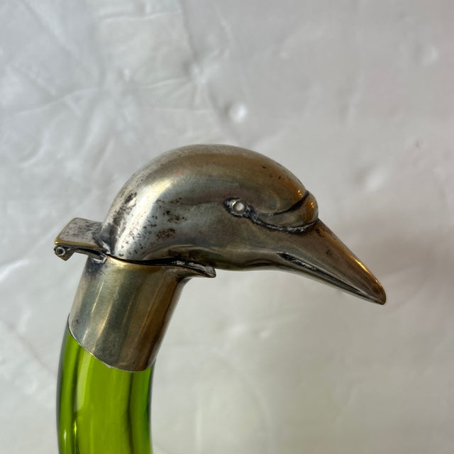 Fully restored, this is an antique pale green glass and silver plate swan decanter. These decanters were made for the...