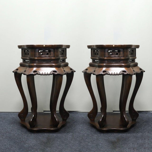 A beautiful pair of Chinese hexagonal plant stands or side tables, likely made of Huali (rosewood). The tops are...