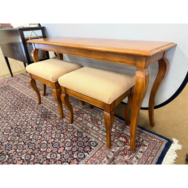 Warm honey-finish console table with a pair of upholstered benches, perfect for an entry, hallway, or behind a sofa. The...