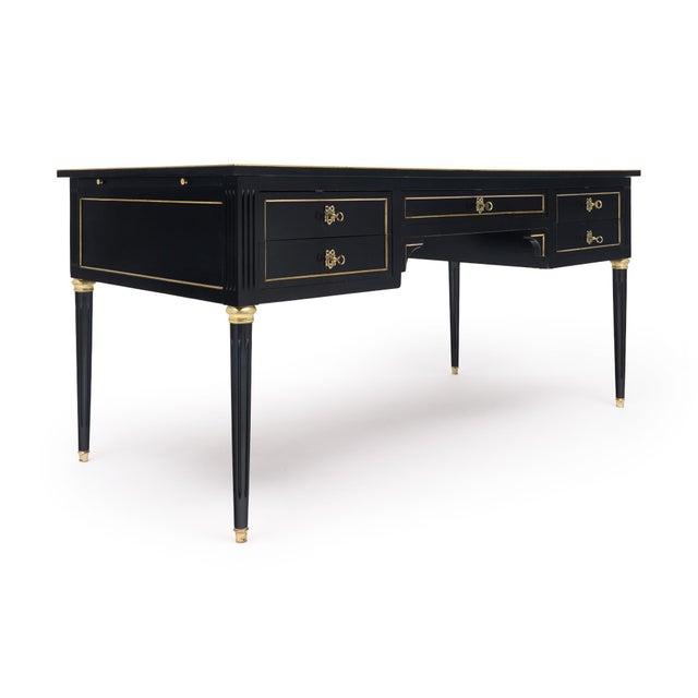 French Louis XVI style desk made of solid wood construction; primarily mahogany. It has been ebonized and finished with a...