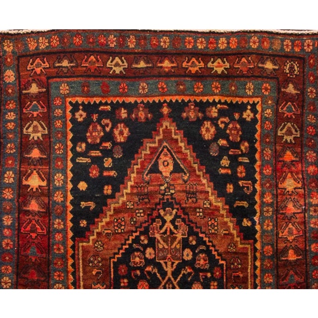 A Beautiful Vintage Malayer Persian Handmade Wool Rug with a red field and multi-color accents in a gorgeous geometric...