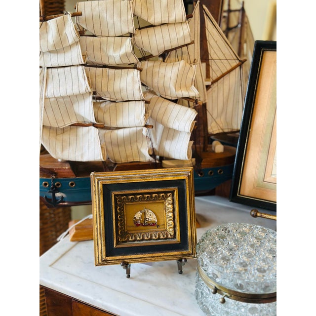 Charming vintage miniature painting featuring a handcrafted sailing ship assemblage displayed within an ornate black and...