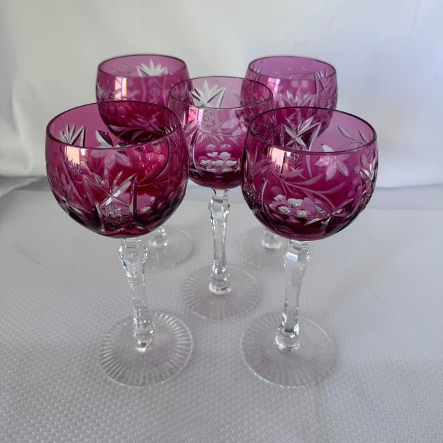 An elegant set of five vintage Nachtmann cranberry cut-to-clear crystal wine glasses, crafted in Germany. Rich ruby...
