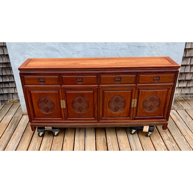 This stunning buffet server features Ming-style horse foot legs with long-life carvings on the door panels and is hand-...