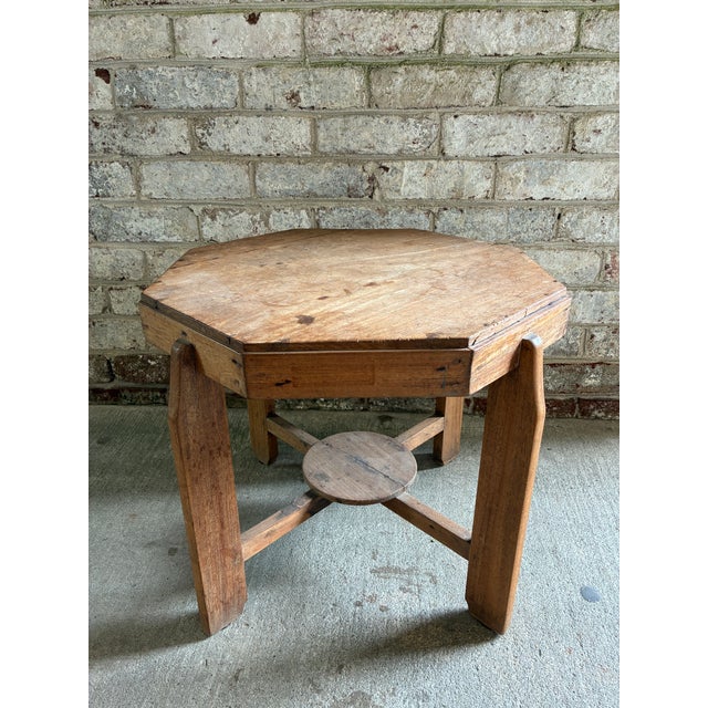 Vintage wooden side table, octagon shaped with four legs. This raw wood end table is from Belgium and was made in the...