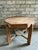 Vintage wooden side table, octagon shaped with four legs. This raw wood end table is from Belgium and was made in the...