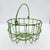 A character-rich vintage wire egg basket with a naturally aged green verdigris patina. The open wire form and swing handle...