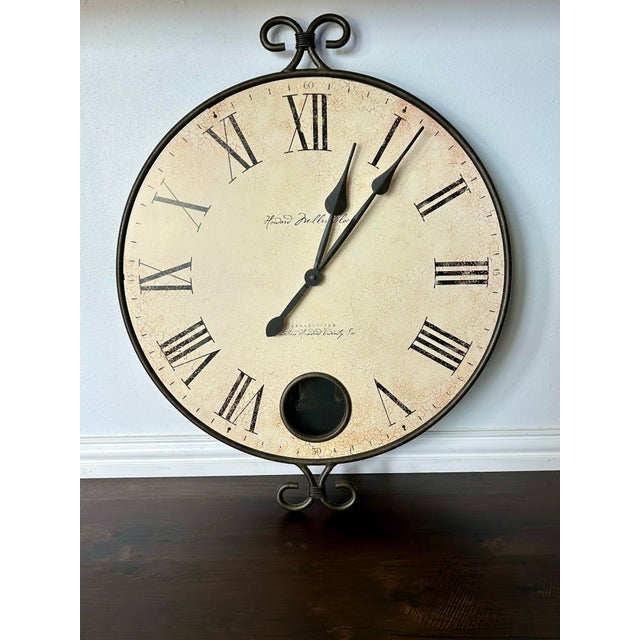 Gorgeous Howard Miller Magellan Wall Clock with an antique crackle dial and wrought iron frame. In excellent condition and...