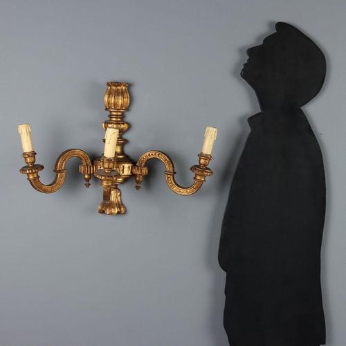 Pair of carved and gilded wood wall lamps. Three lights supported by curved arms. Italy, early 20th century. This piece is...