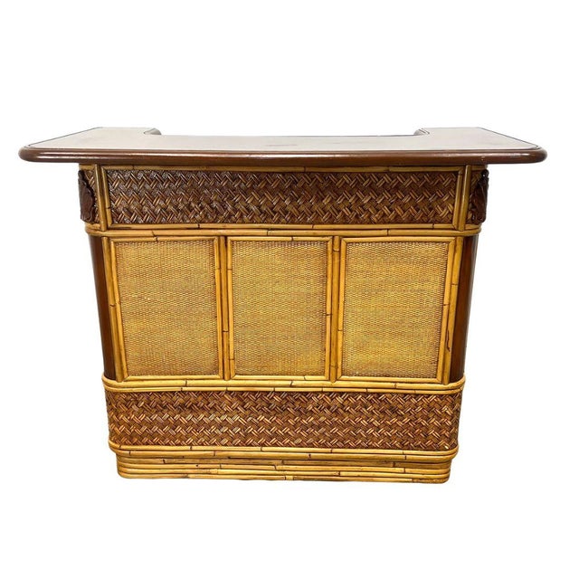 Mid century modern vintage rattan and wicker bar set with two stools. crafted with a combination of woven wicker panels...