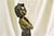 An elegant Lady walking down the steps cast in bronze with multi-patinas. Mounted on a solid marble grand staircase. Title...