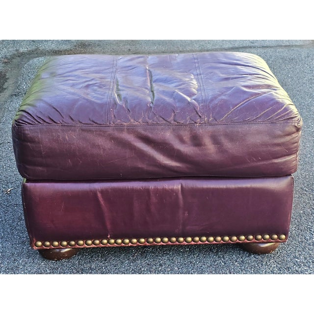 A large , comfortable Robinson and Robinson Furniture Top Grain Leather Ottoman in burgundy color. Soft top grain leather....