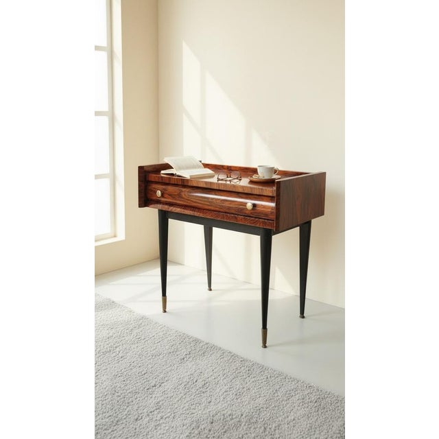1960s rosewood bedside table Tapered legs in black-stained wood / brass feet. The front legs are adjustable with screw-in...