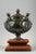 A patinated bronze pedestal urn with a ball-shaped lid decorated with acanthus leaves, ovals and entwined snakes. On the...