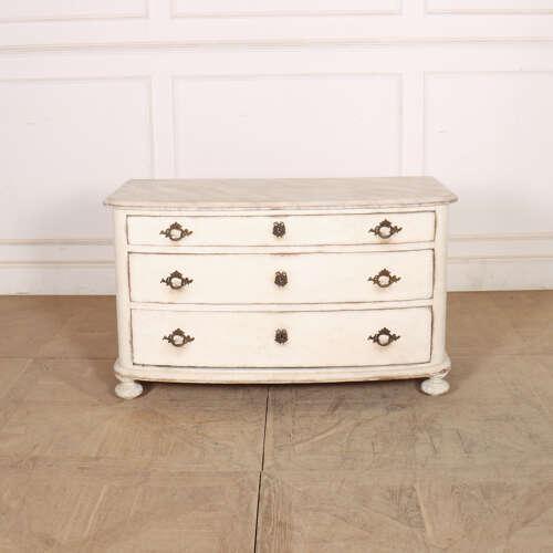19th century French painted three drawer bow front beech commode with a faux marble top. 1840. This piece is designed in...