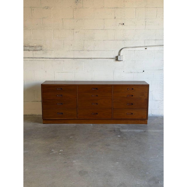 This substantial dresser features a clean, monolithic silhouette with a flush plinth base. Designed by Jack Cartwright, it...