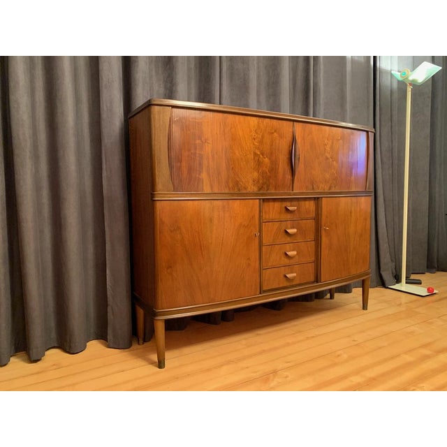 A unique Danish highboard from the 1950s. In original and good condition. On the right side of the base, a small hole was...