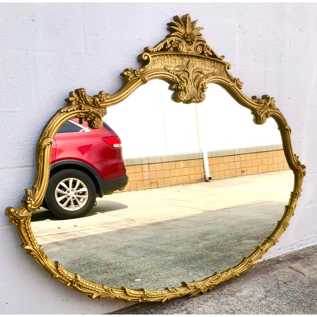 Beautiful early t20th century large ornate gol.d Rococo wall mirror. WOW! Beautiful scrollwork and flowers. Ornate shape....