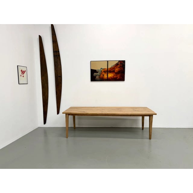 Its 4 cm thick rectangular top reveals a beautiful oak grain and a warm hue. The slightly angled spindle legs create an...