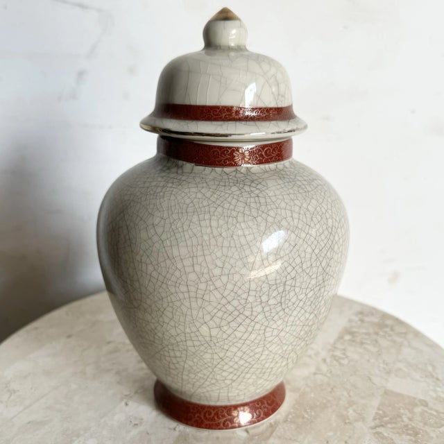 This vintage Japanese porcelain ginger jar exudes timeless elegance with its crackled glaze finish and intricate floral...