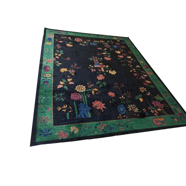 This navy blue antique wool-pile hand-knotted Chinese Art Deco area rug is a refined example of early 20th-century textile...