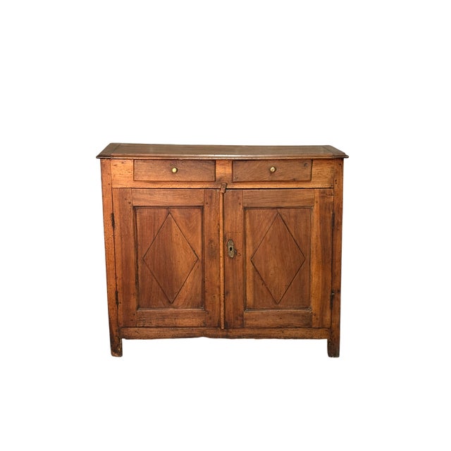 An elegant 19th-century walnut sideboard with two drawers and two doors. The front is embellished with diamond-patterned...