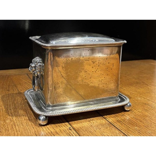English Silver Plate Tea Caddy with Lions Head Handles Sizes. 18 x 14 cms, 13 cms tall. A used item so will have signs of...