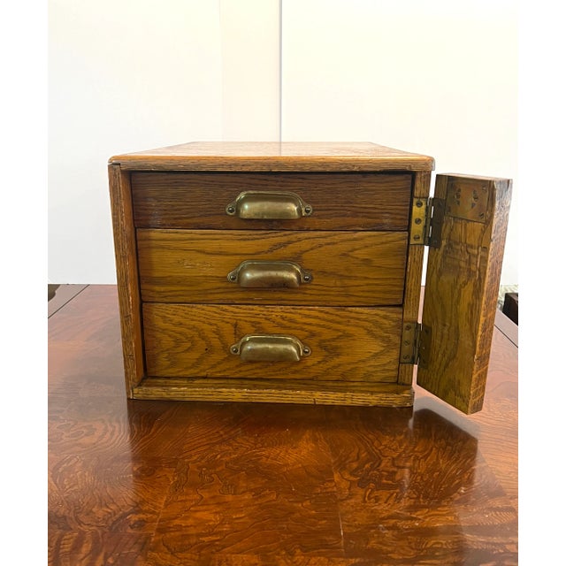 This is an original locking cash and stamp safe/box made for the post office. It has 3 drawers with money slots and stamps...