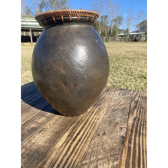 Vintage pottery vase with a woven rattan top. Primitive design, unique and perfect for rustic or vintage decor. A...