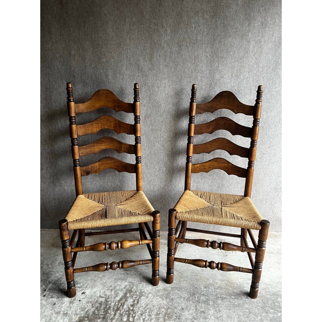Vintage pair of French Country ladder back chairs with woven rush seats. These chairs stand out for the beautiful wood...
