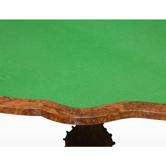 Walnut serpentine front card table. The folding and swivel burr walnut top opening to reveal a inset baize lined interior...