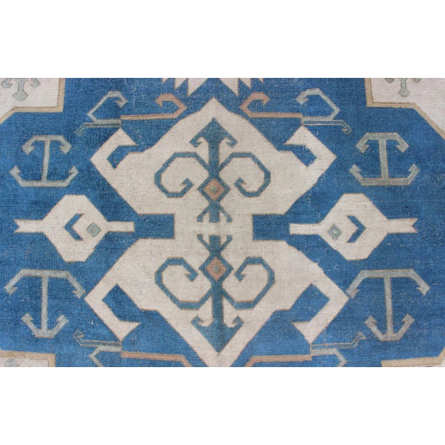 Large vintage Turkish rug with stylized geometric design in blue, ivory, tan. Keivan Woven Arts / rug 16-0914, country of...