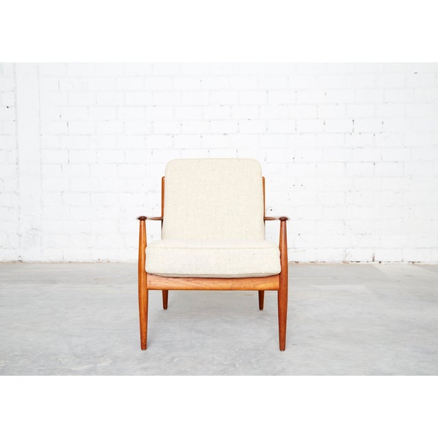 Condition: Very good condition with minor signs of wear. Frame made of solid teak. Upholstered in light-colored wool. This...