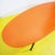 Oval coffee table featuring an orange wooden top and a metal base from the 1970s.