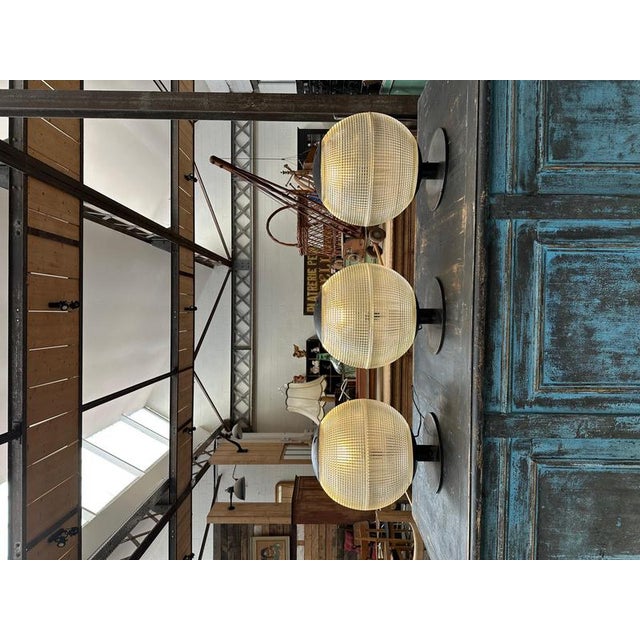 Series of 3 holophane table lamps, made from old Parisian street lighting globes. These spherical refractory globes were...