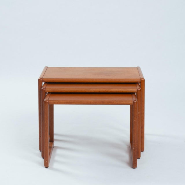 Danish teak mid century modern nesting tables with rounded edge 'sleigh legs'. Beautiful original finish shows little wear...