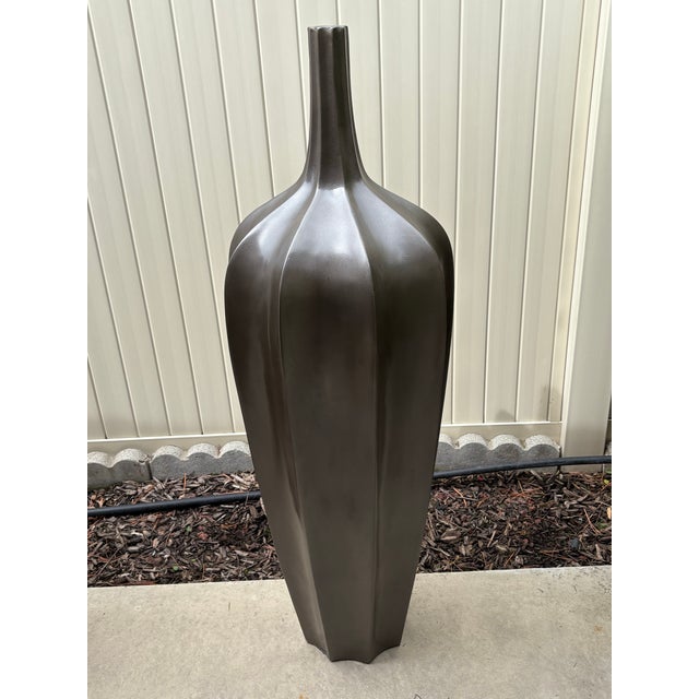 This pair of vintage bronzed large accolade floor vases is a high-end design statement item for any home. The design...