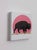 This artwork features a solitary bison set against a vibrant pink sunset, its silhouette rendered in rich charcoal and...