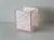 A vintage 1960s pearlized light pink acrylic and Lucite bathroom wastebasket, featuring a clear outer frame and a...